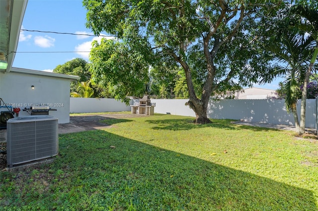 view of yard featuring central air condition unit