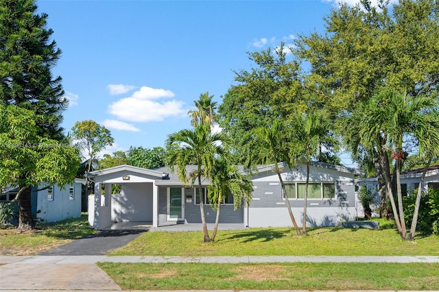 single story home featuring a front lawn and a carport