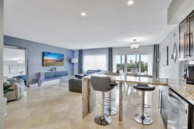 tiled living room featuring a notable chandelier