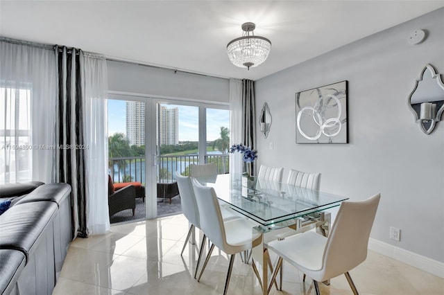 dining area featuring a water view and a chandelier