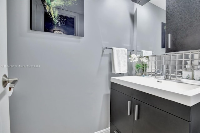 bathroom with decorative backsplash and vanity