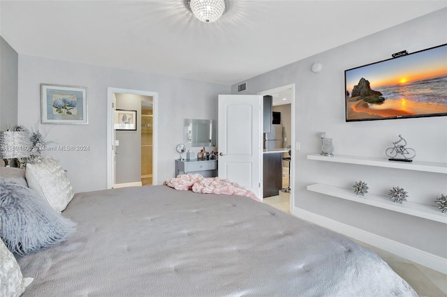 bedroom featuring connected bathroom and light carpet