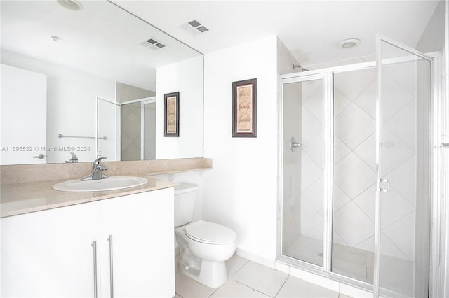 bathroom with tile patterned flooring, vanity, and a shower with shower door