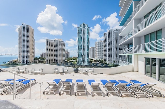 view of swimming pool with a water view and a patio