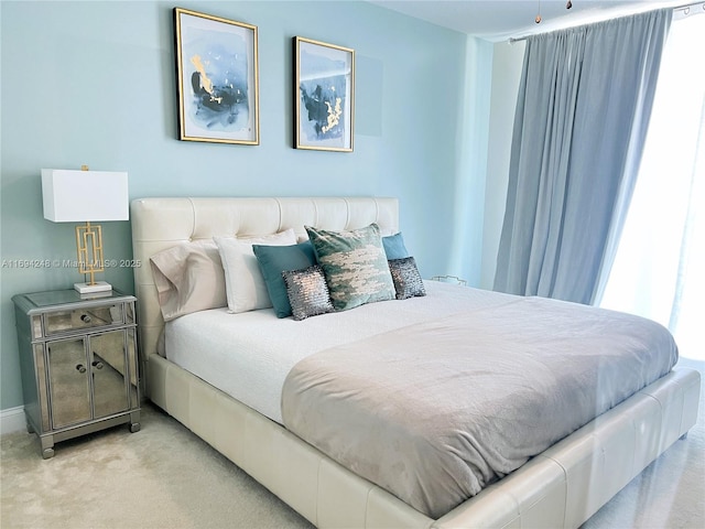 bedroom featuring light colored carpet