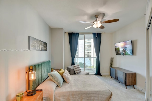 bedroom with light carpet, access to exterior, floor to ceiling windows, and ceiling fan