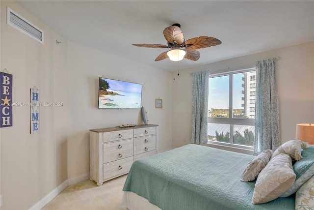 bedroom featuring ceiling fan and light colored carpet