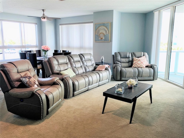 carpeted living room with ceiling fan