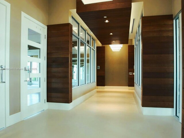 corridor with a healthy amount of sunlight and wooden ceiling