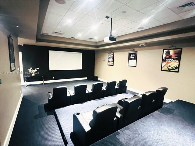 cinema featuring carpet floors and a drop ceiling