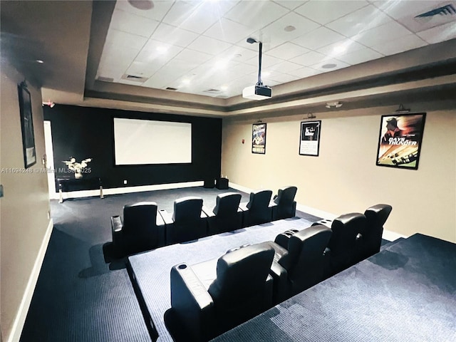 home theater featuring a drop ceiling and a tray ceiling