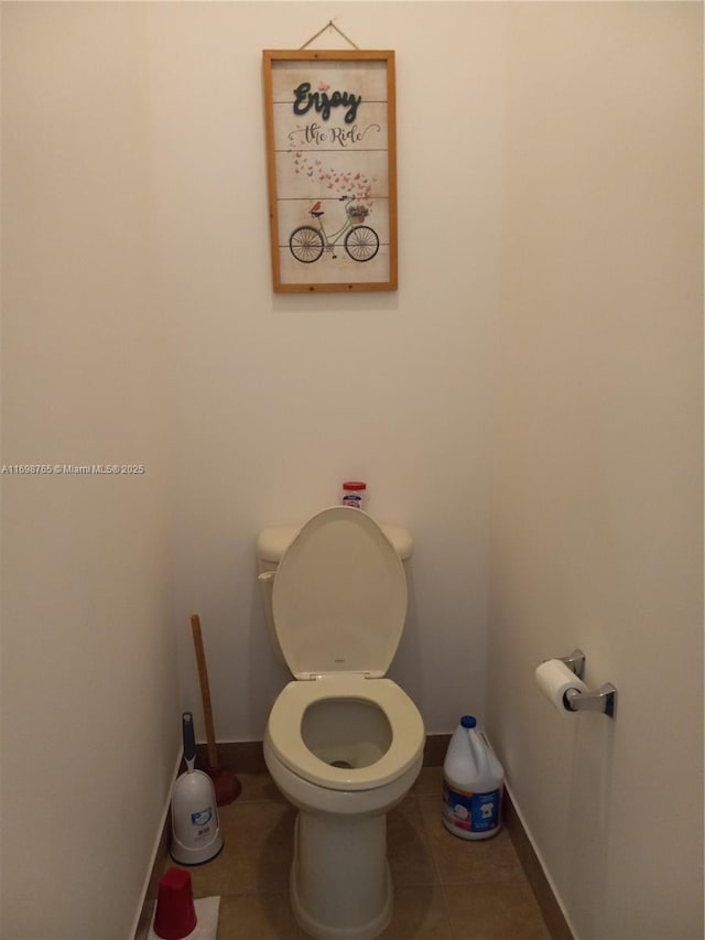 bathroom with toilet and tile patterned flooring