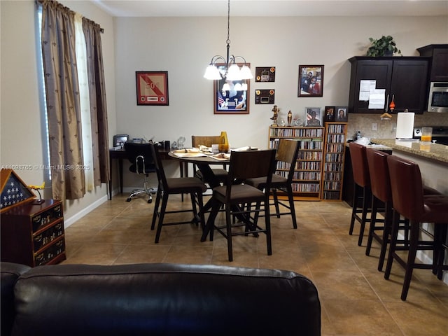 dining area featuring a notable chandelier and tile patterned flooring