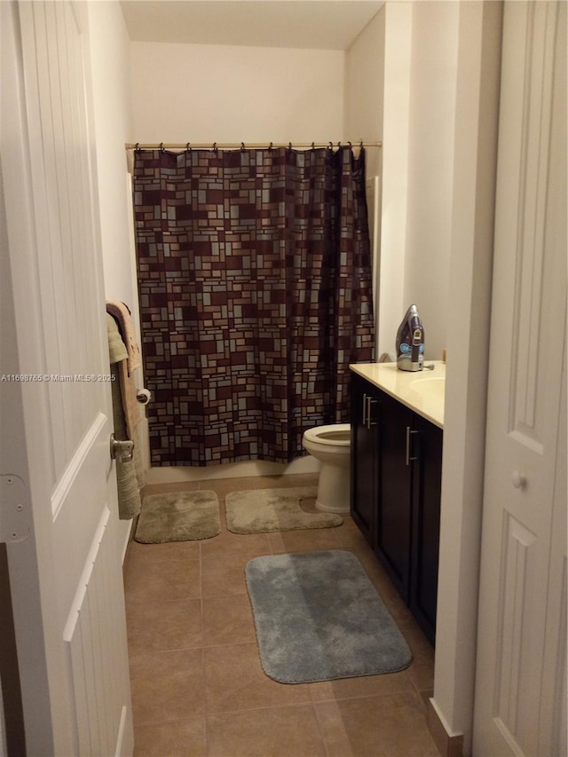 full bathroom with shower / bath combo, toilet, tile patterned floors, and vanity