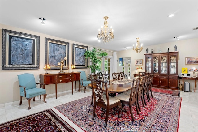 tiled dining area featuring a chandelier