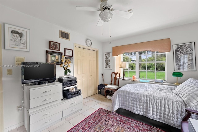 bedroom featuring a closet, ceiling fan, and light tile patterned flooring