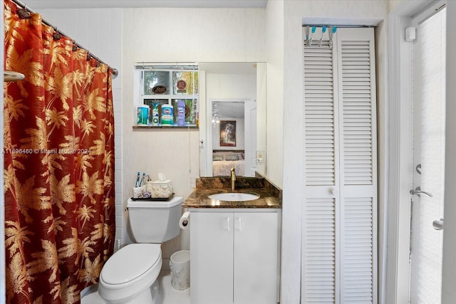 bathroom featuring tile patterned floors, vanity, and toilet