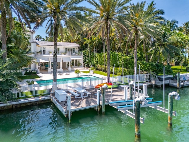 dock area featuring a patio area, a fenced in pool, and a water view