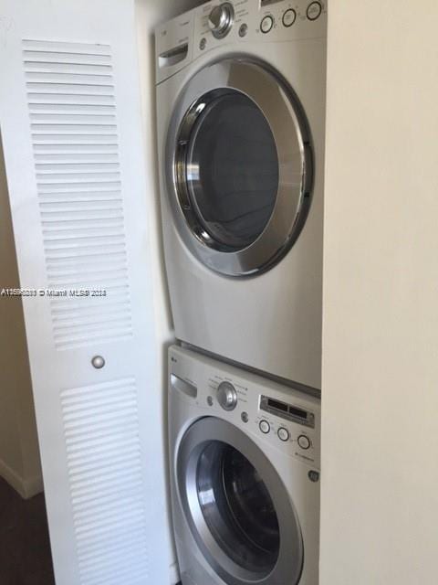 clothes washing area with stacked washer / drying machine