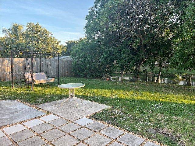 view of yard featuring a patio and a water view