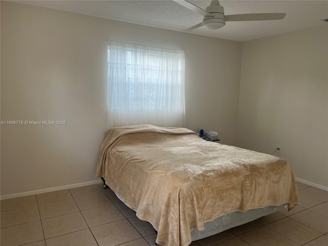 bedroom featuring light tile patterned floors and ceiling fan