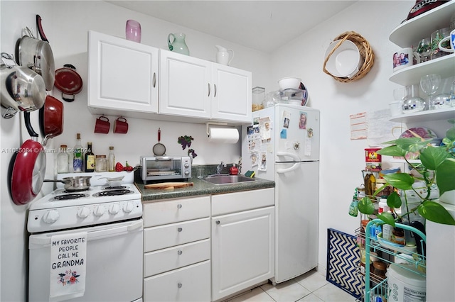 kitchen with white cabinets, light tile patterned flooring, white appliances, and sink