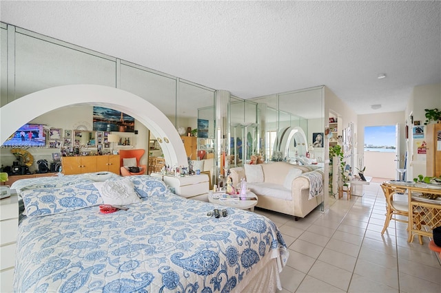 tiled bedroom featuring a textured ceiling