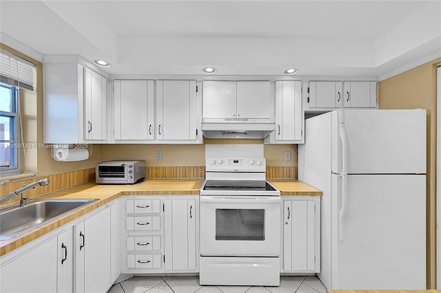 kitchen featuring light countertops, white appliances, a sink, and under cabinet range hood