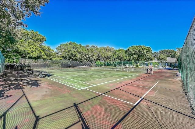 view of tennis court with fence