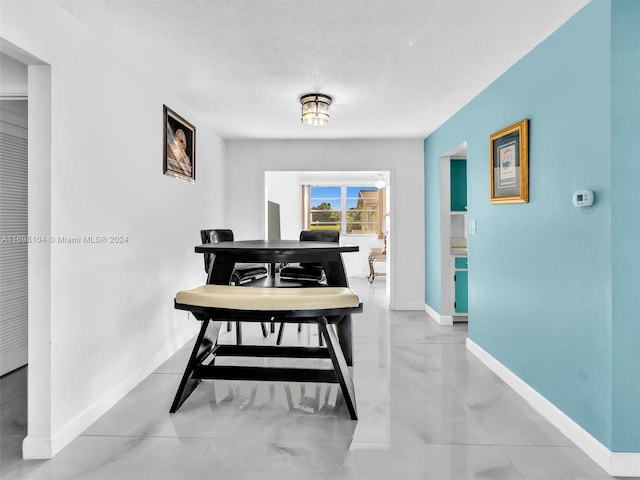 hall with a textured ceiling