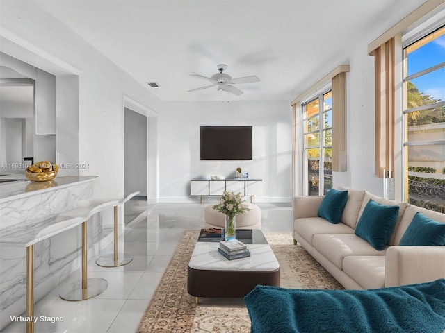 tiled living room featuring ceiling fan