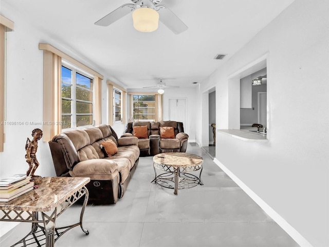 living room featuring ceiling fan and sink