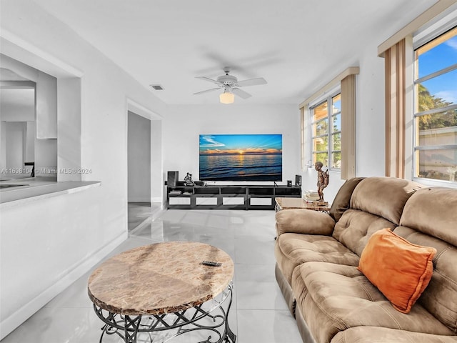 tiled living room with ceiling fan