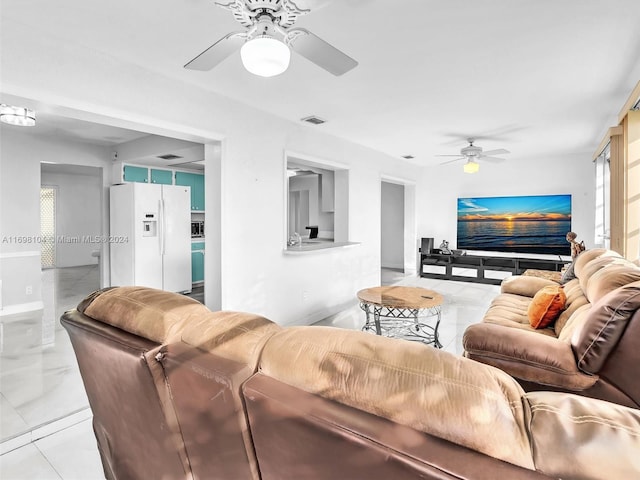 tiled living room featuring ceiling fan