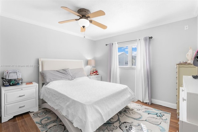 bedroom featuring ceiling fan, ornamental molding, and light wood-type flooring