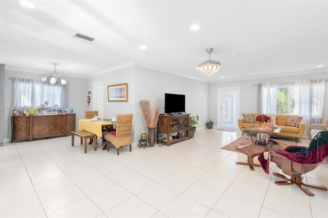 tiled living room with crown molding and an inviting chandelier