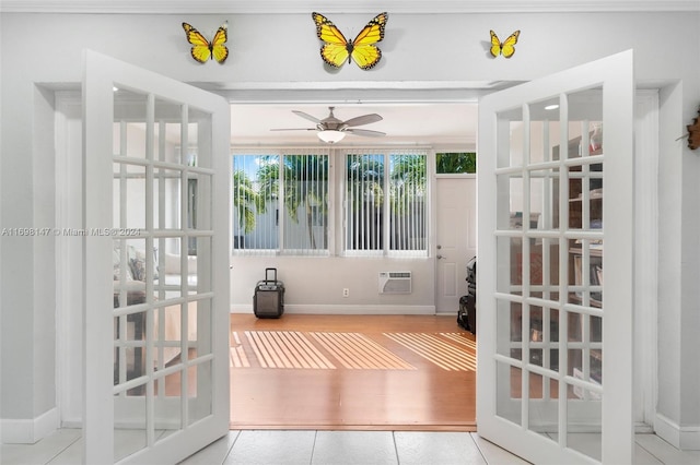 sunroom featuring a wall mounted air conditioner, french doors, and ceiling fan