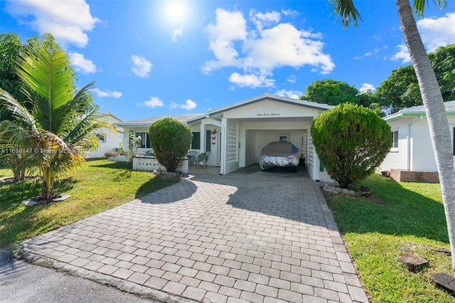 ranch-style house with a front yard and a carport