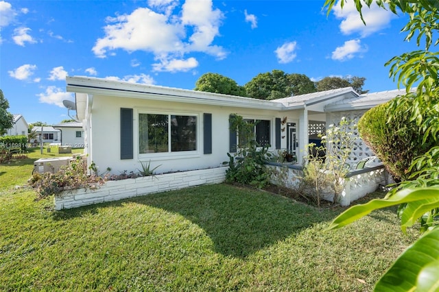 rear view of house featuring a lawn