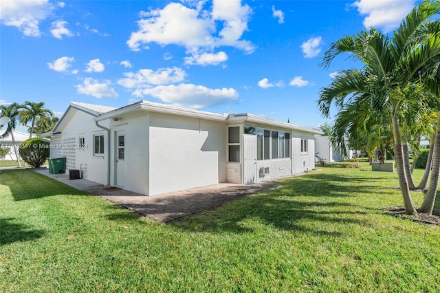 rear view of house featuring a yard