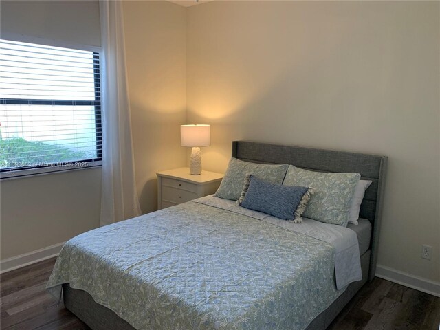 bedroom featuring dark hardwood / wood-style flooring