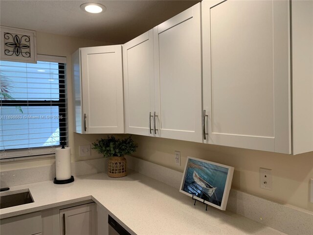 kitchen featuring white cabinetry, sink, and black range with electric cooktop