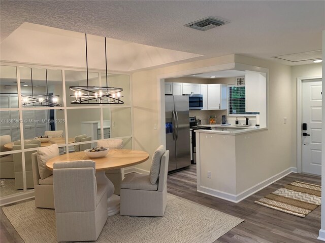 carpeted dining area with an inviting chandelier