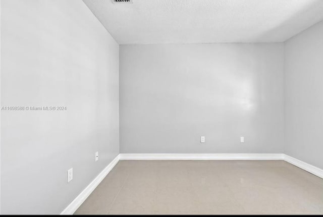 empty room featuring a textured ceiling