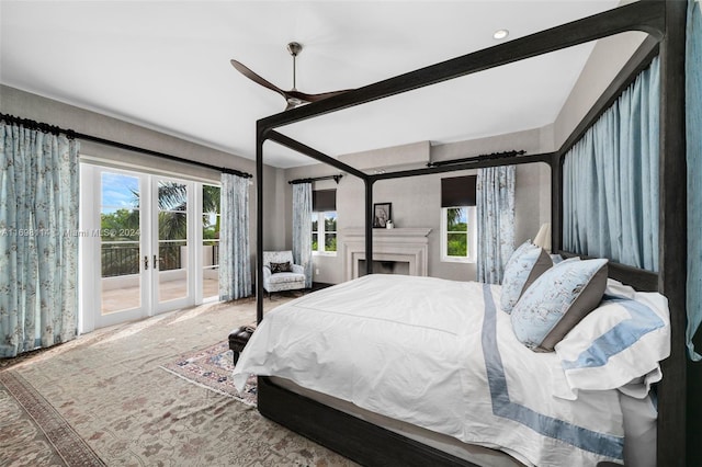 bedroom with access to outside, multiple windows, ceiling fan, and french doors