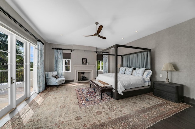 bedroom with hardwood / wood-style floors, ceiling fan, and access to outside