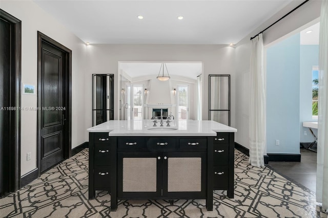 3305 S Moorings Way, Miami, FL 33133 - kitchen featuring dark cabinets, a sink, baseboards, light countertops, and recessed lighting