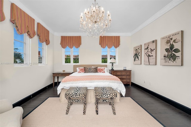 bedroom featuring dark hardwood / wood-style flooring, ornamental molding, and an inviting chandelier