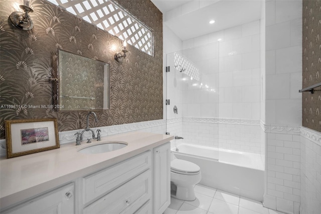 full bathroom with vanity, tiled shower / bath combo, toilet, and tile patterned flooring