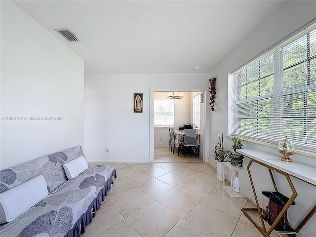 living room with a wealth of natural light and light tile patterned flooring